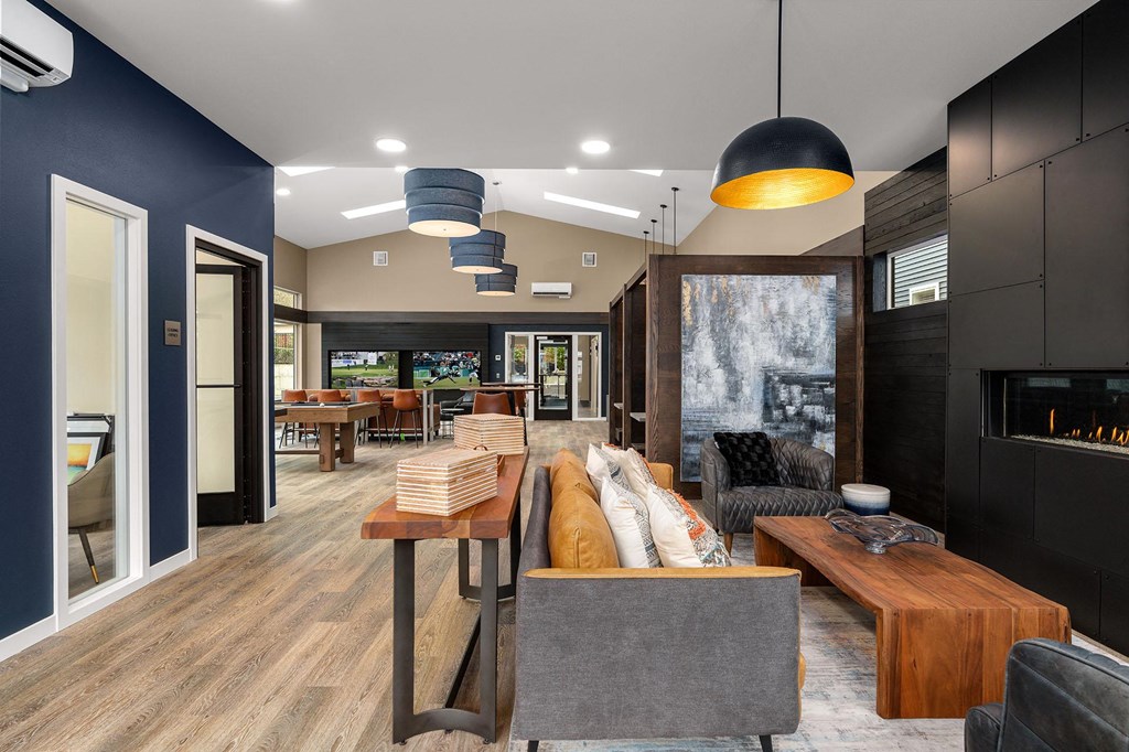 A modern living room with a grey couch and a wooden coffee table.