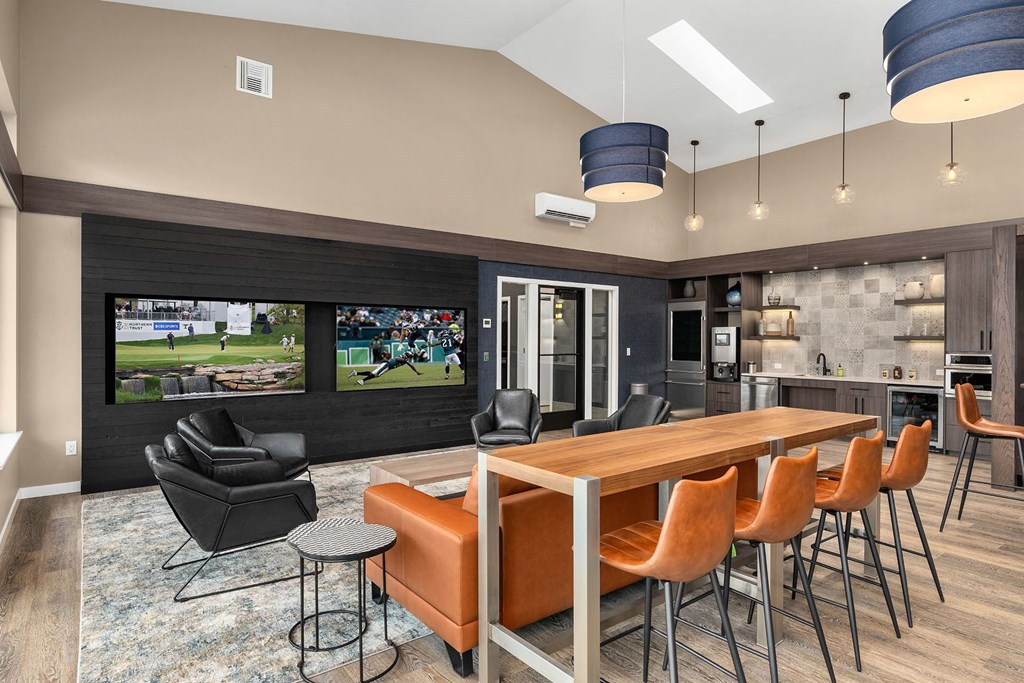 A modern dining room with a large table and chairs.