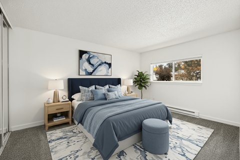 A bedroom with a large bed and a painting on the wall.