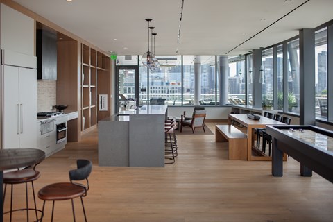 A modern kitchen with a dining table and chairs.