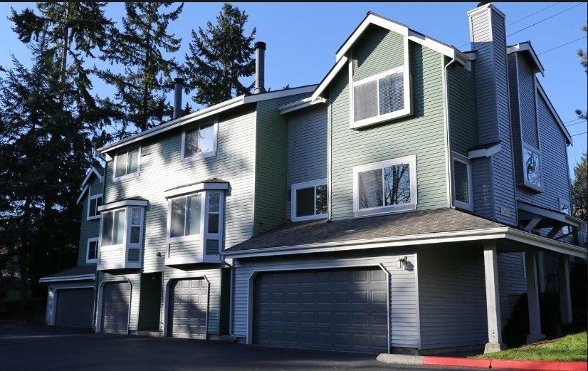 a green and white house with a garage