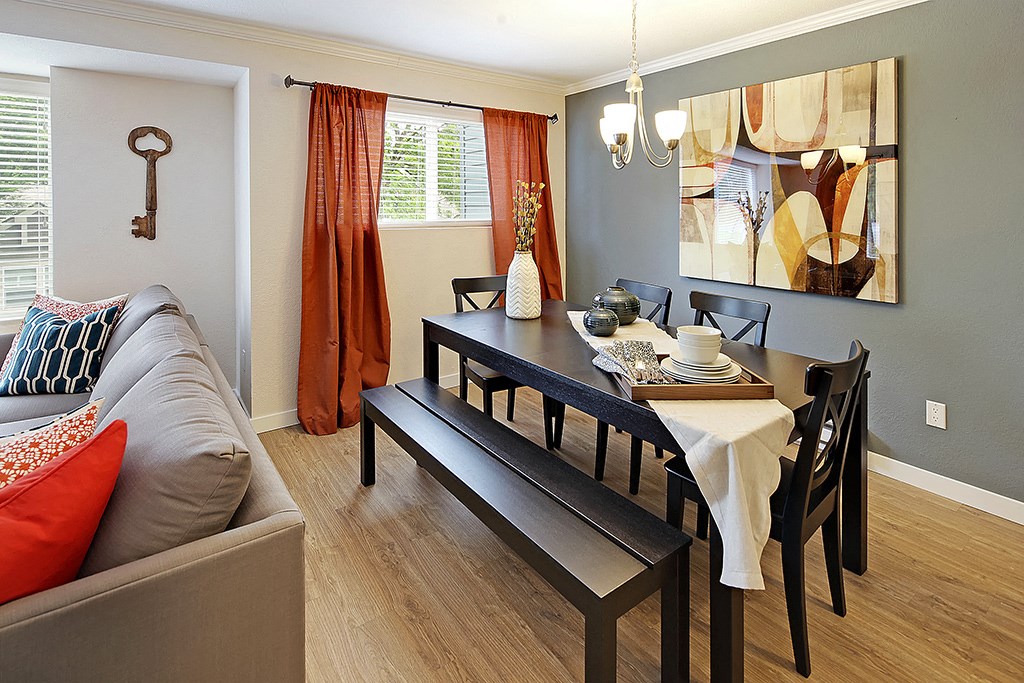 a dining room with a table and chairs and a couch