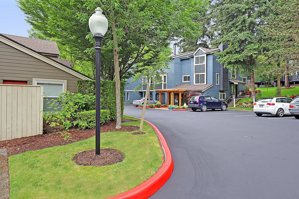 a street with cars parked in front of houses