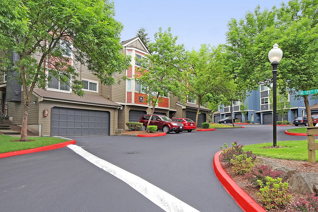 a street with cars parked in front of a building