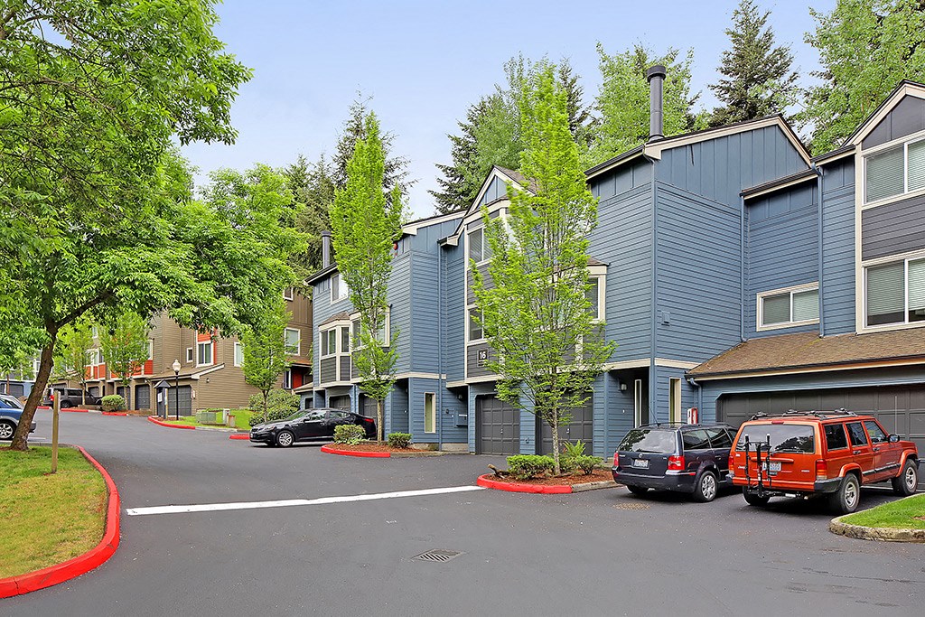 a street with cars parked in front of a building