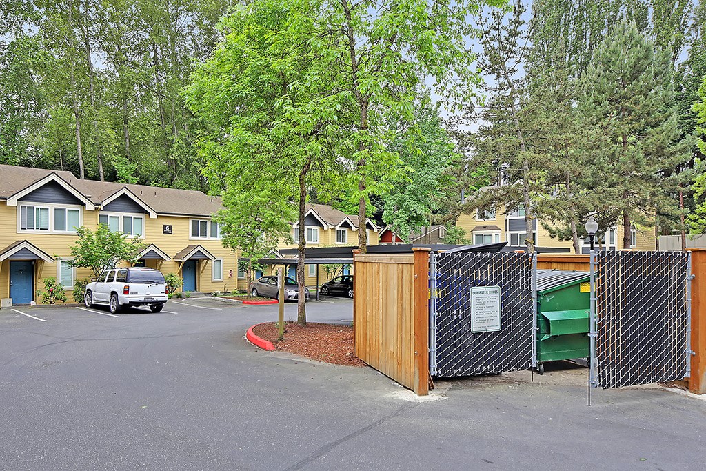 a fenced in yard with houses in the background