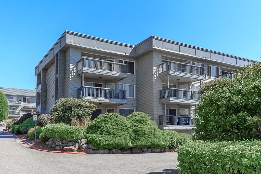 an apartment building with a street in front of it