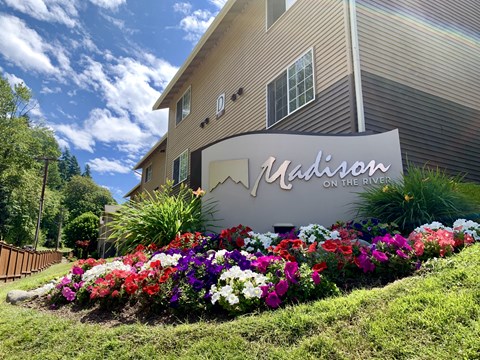 A building with a sign that says "Madison" in front of it.
