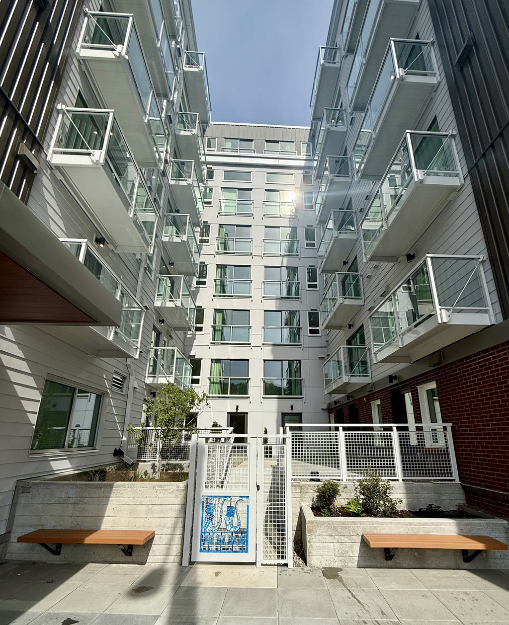 A modern building with a white facade and balconies.