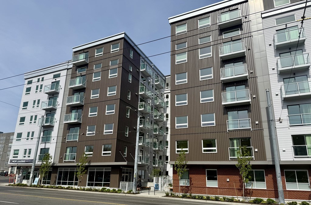Two modern apartment buildings with balconies and windows.