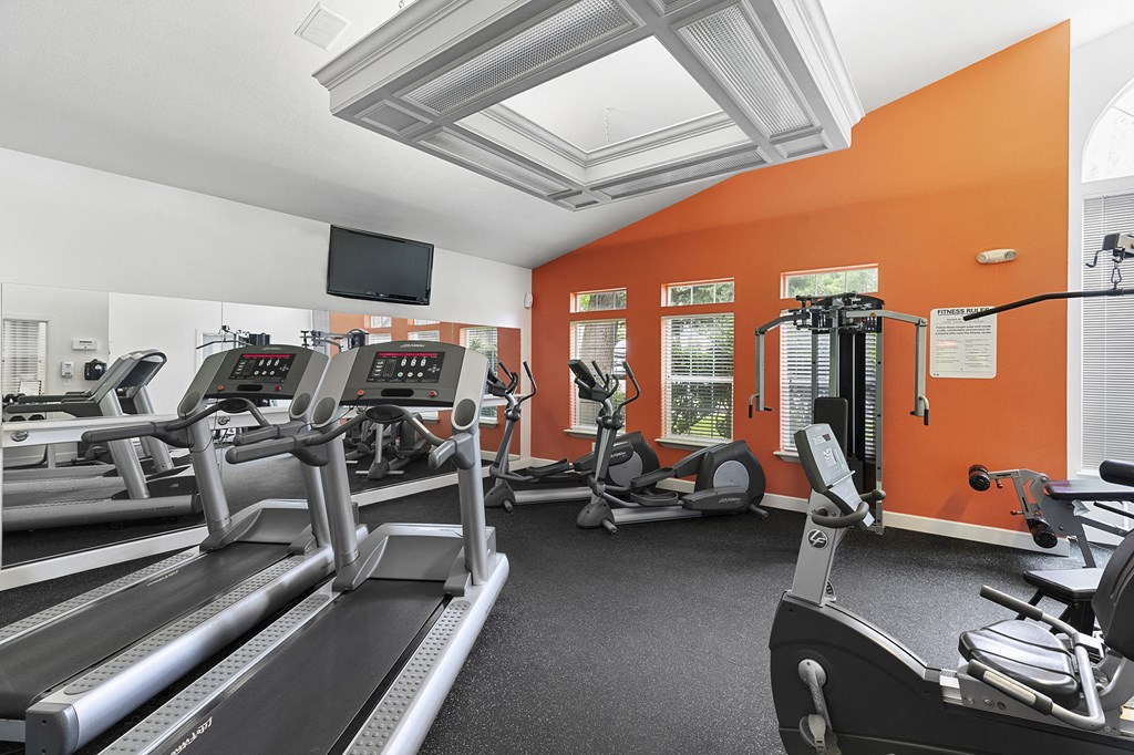 a gym with treadmills and other exercise equipment