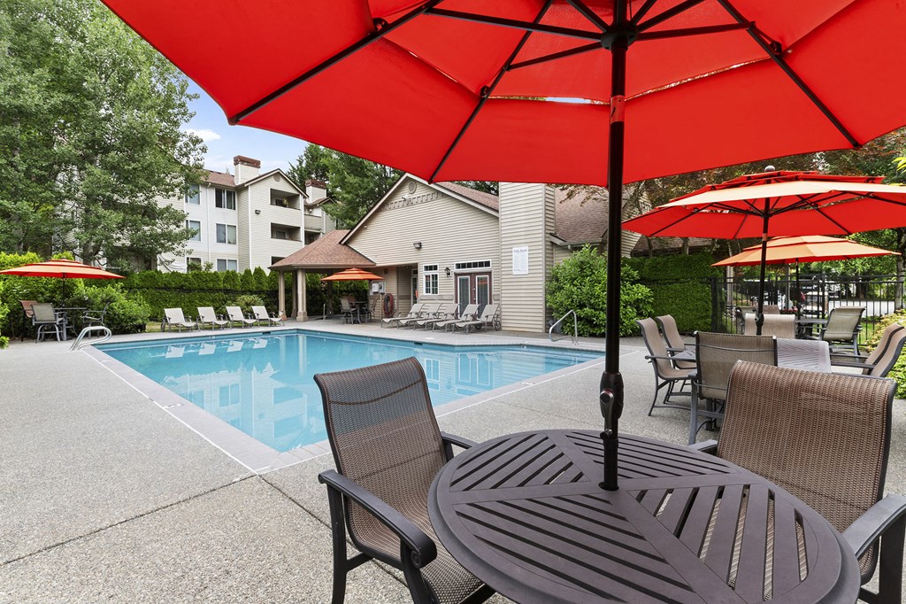 our apartments have a swimming pool and table with umbrellas