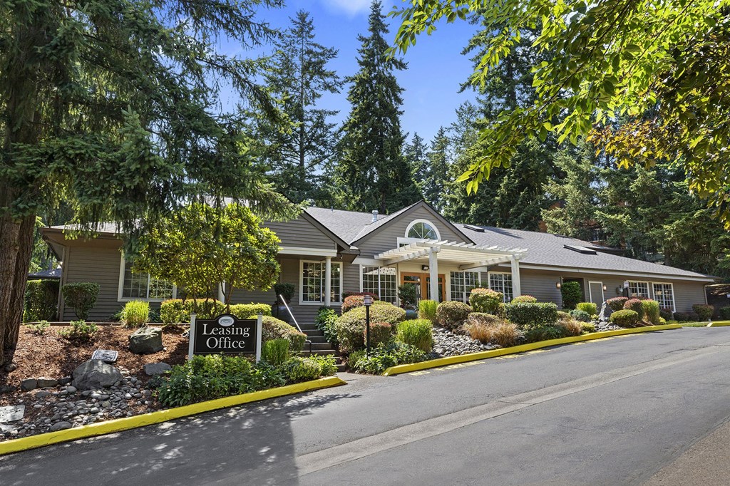 a house with a driveway and a sign in front of it