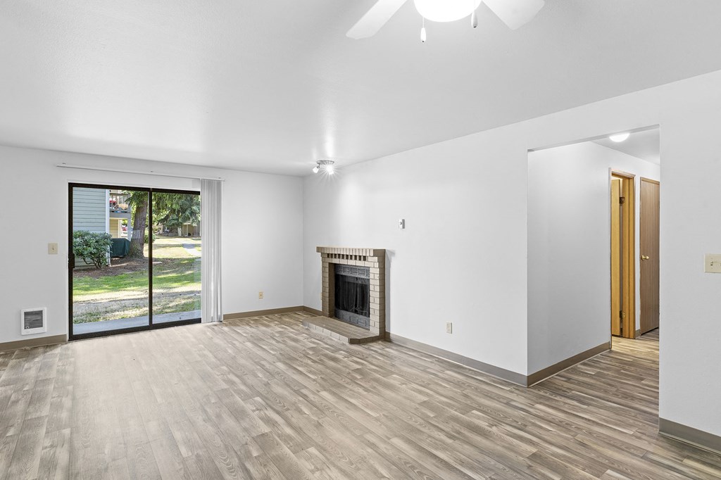 a living room with a fireplace and a sliding glass door