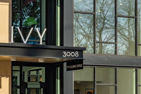 the facade of a building with a black sign on the front of it