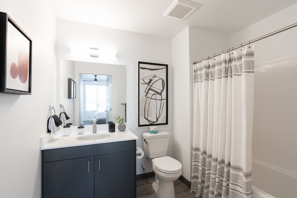 a bathroom with a shower and a toilet and a sink