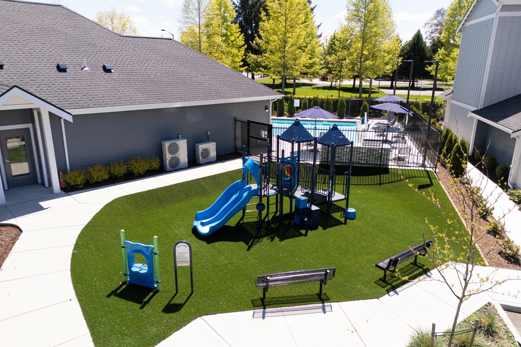 a playground is shown in the backyard of a house