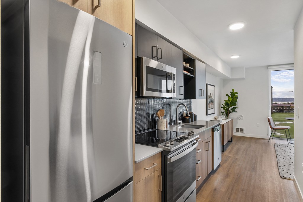 an apartment kitchen with stainless steel appliances and a stainless steel refrigerator