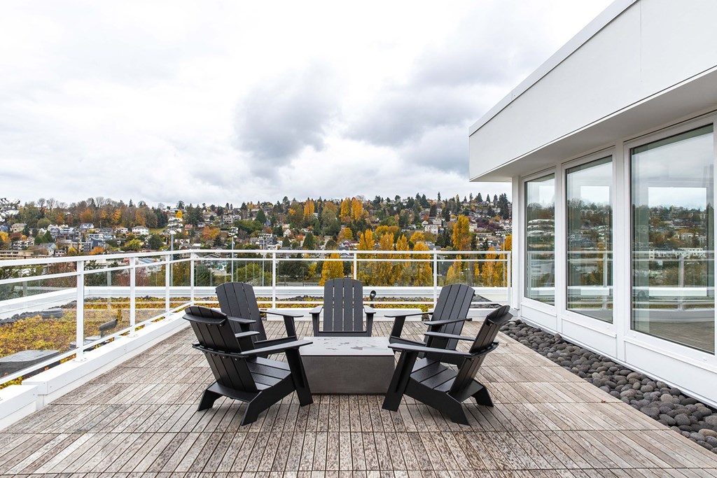 a patio with chairs and a table on a balcony