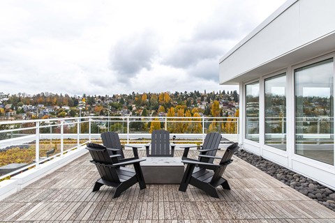 a patio with chairs and a table on a balcony