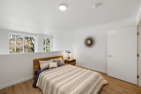a bedroom with a bed and a window