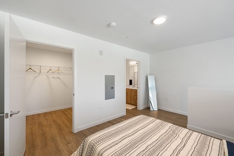 a bedroom with a large bed and a closet with a mirror