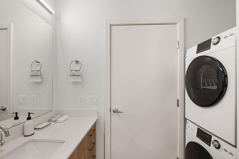 a white laundry room with a washer and dryer in it