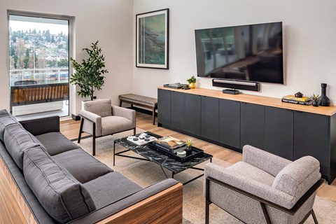 a living room with a couch and chairs and a television
