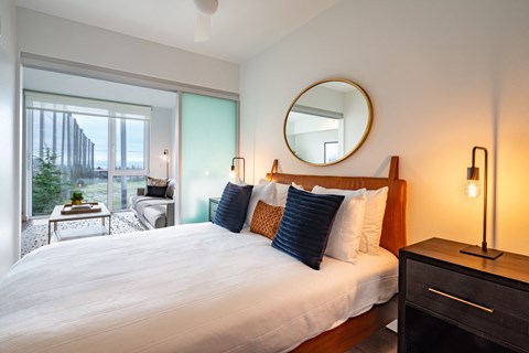 a bedroom with a large bed and a large window