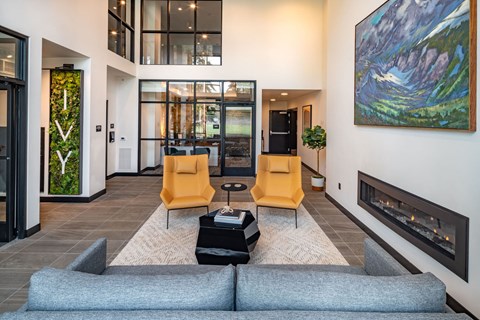 a living room with a couch and chairs and a fireplace