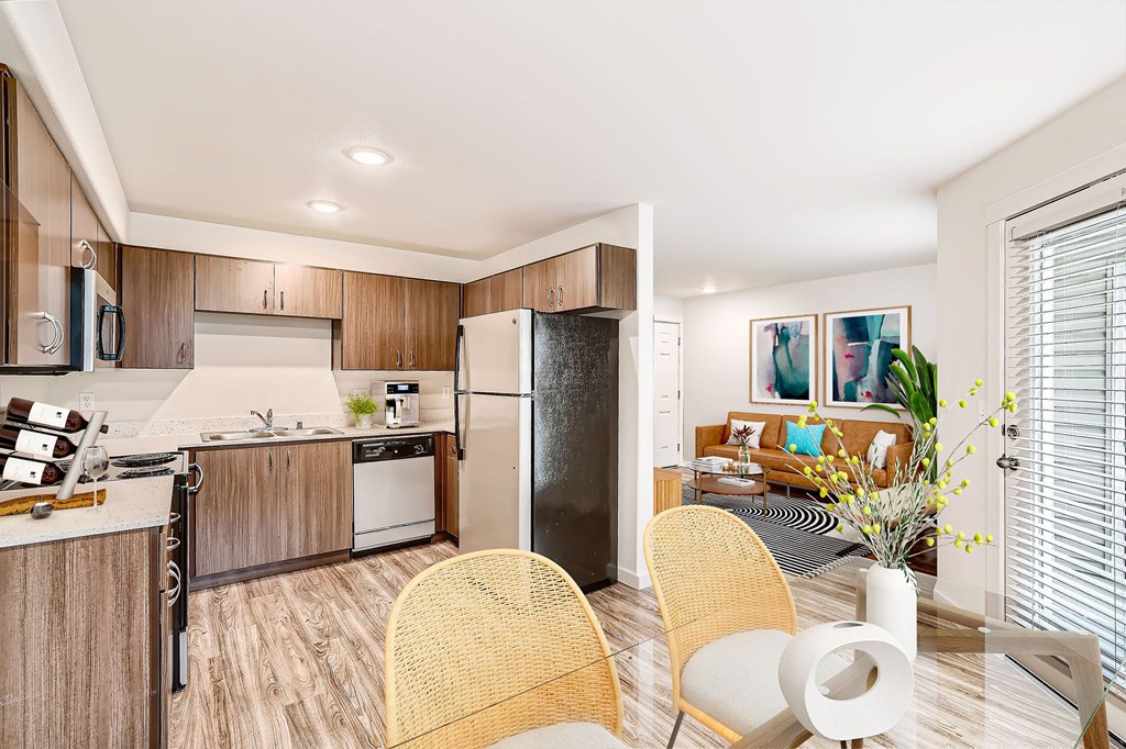 a kitchen with stainless steel appliances and a table with chairs