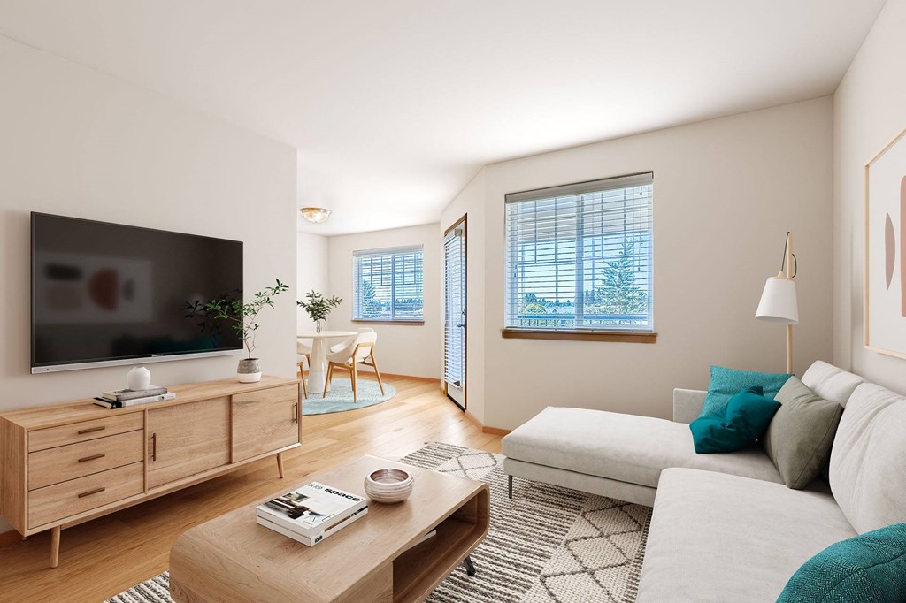 A living room with a television, a couch, and a coffee table.