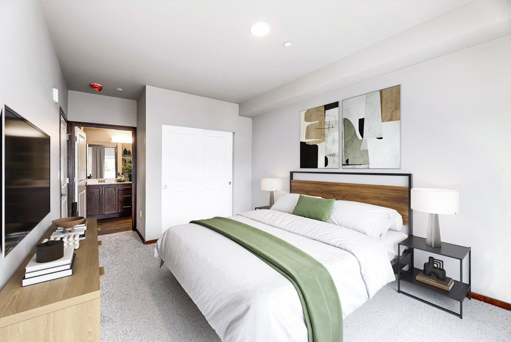 a bedroom with a large bed and a bathroom