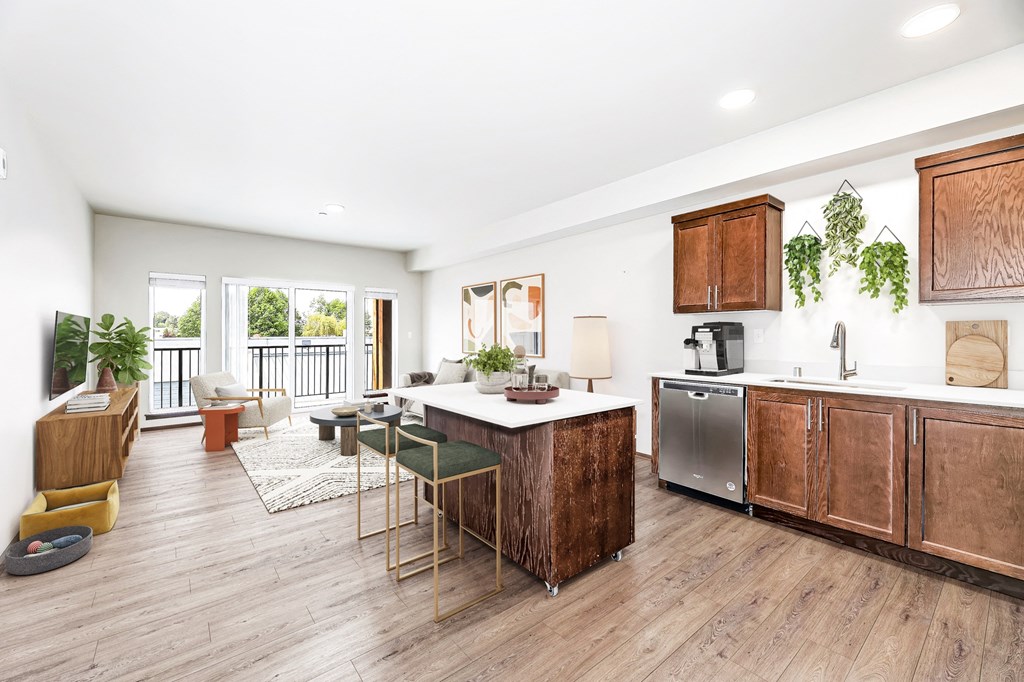 a large living room with a kitchen and a balcony