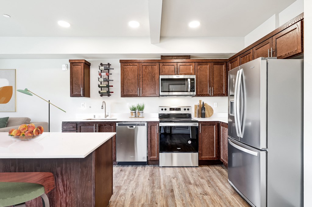 a kitchen with stainless steel appliances and wooden cabinets