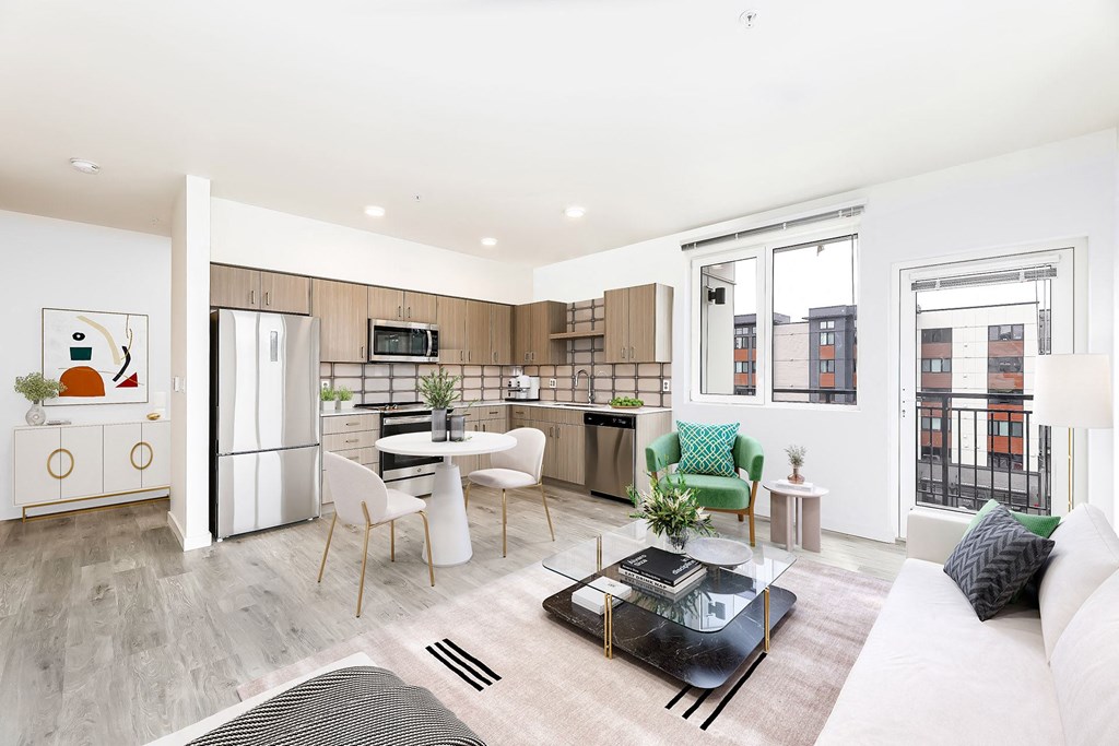 a living room with a kitchen and a table