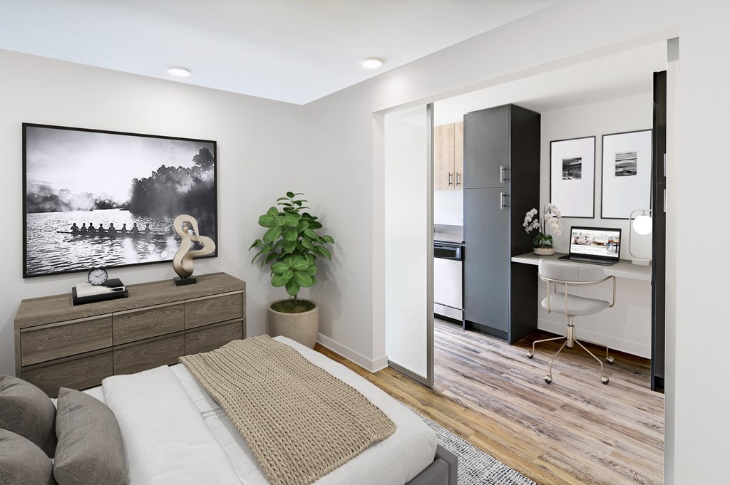 a bedroom with a bed and a desk and a tv