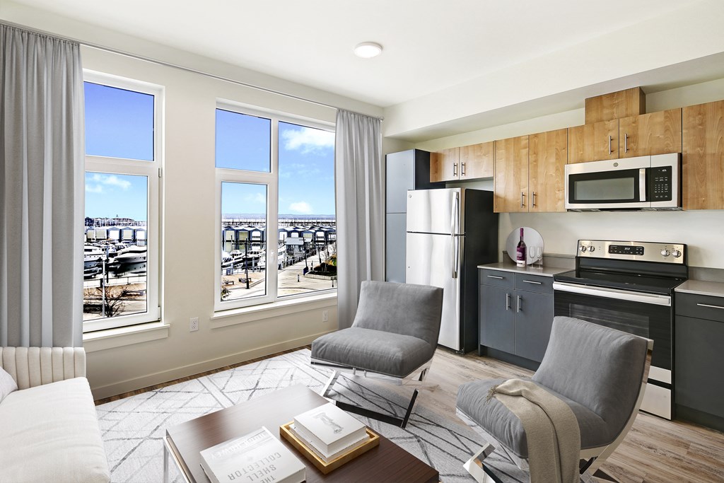 a kitchen and living room with a view of a city
