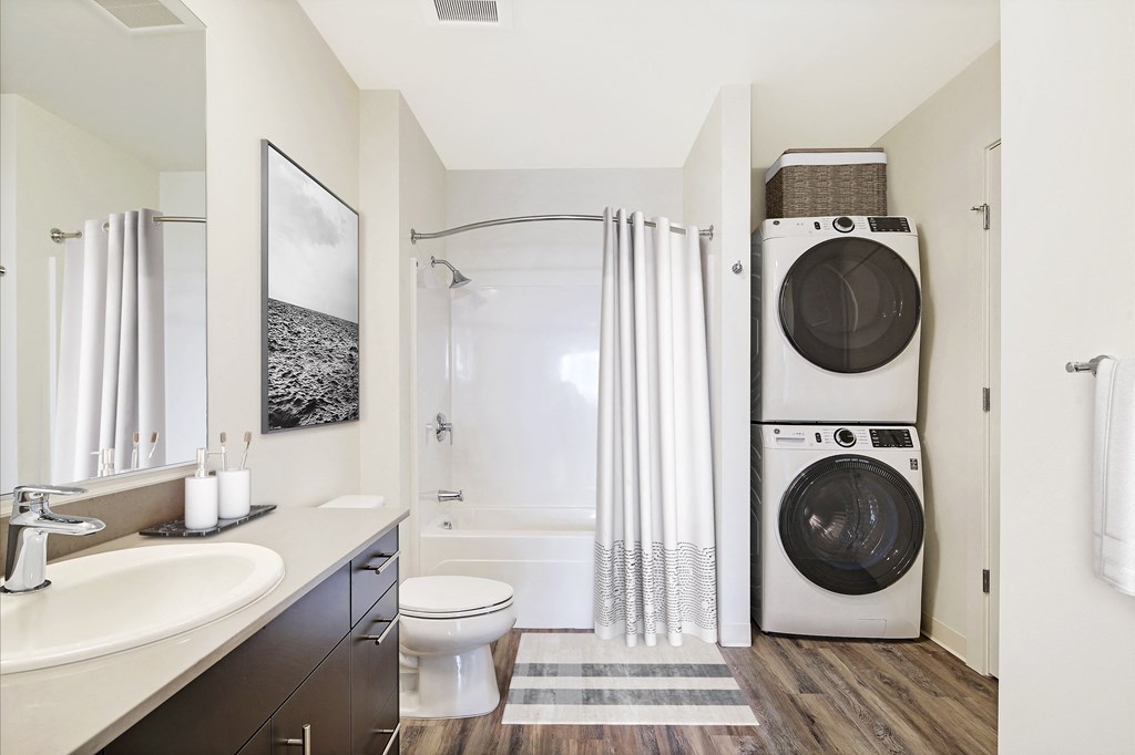 a bathroom with a washer and a dryer in it