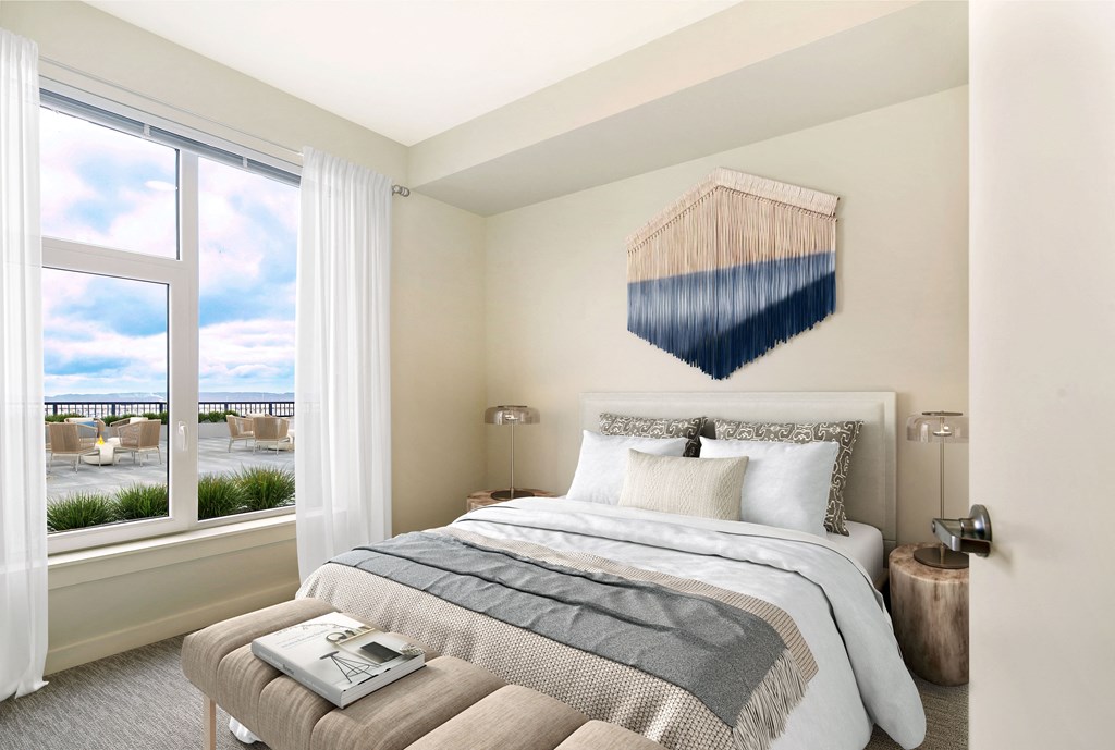 a bedroom with a bed and a large window