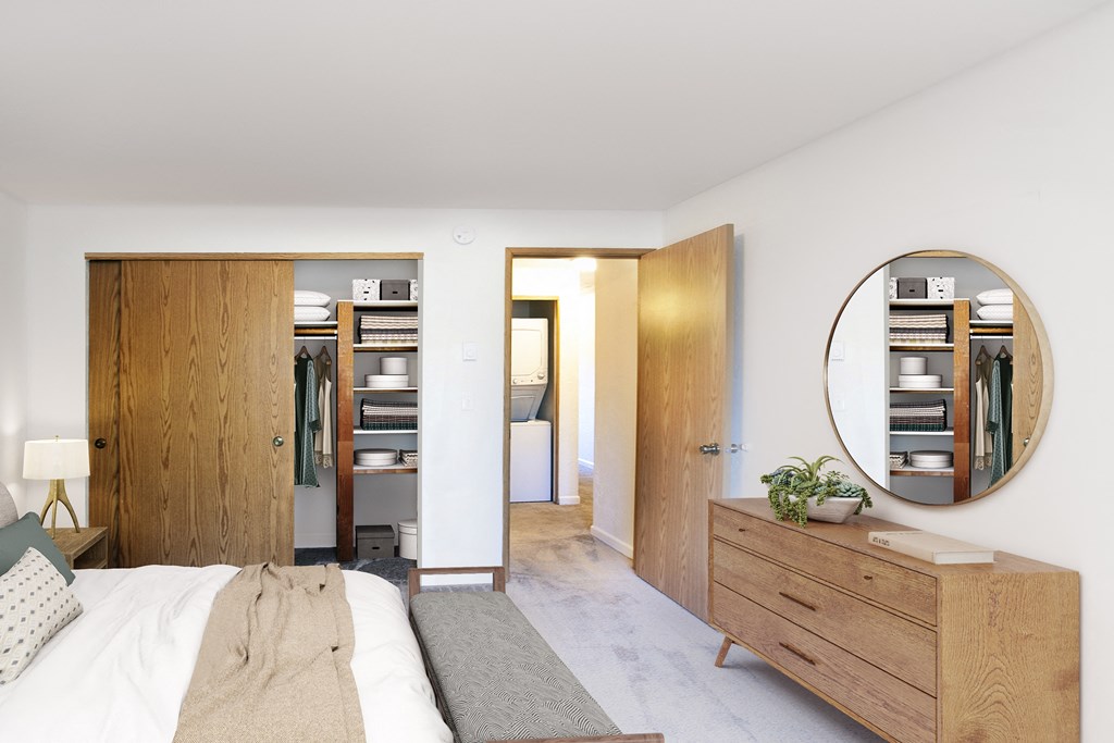 a bedroom with a bed and a mirror