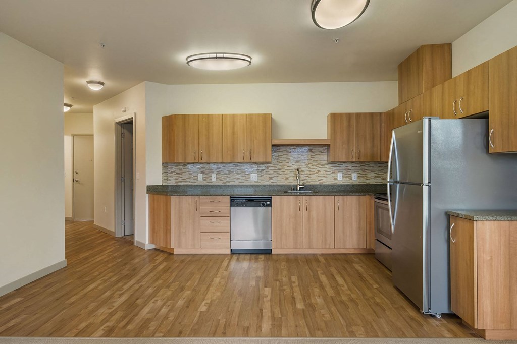 a kitchen with wooden cabinets and stainless steel appliances