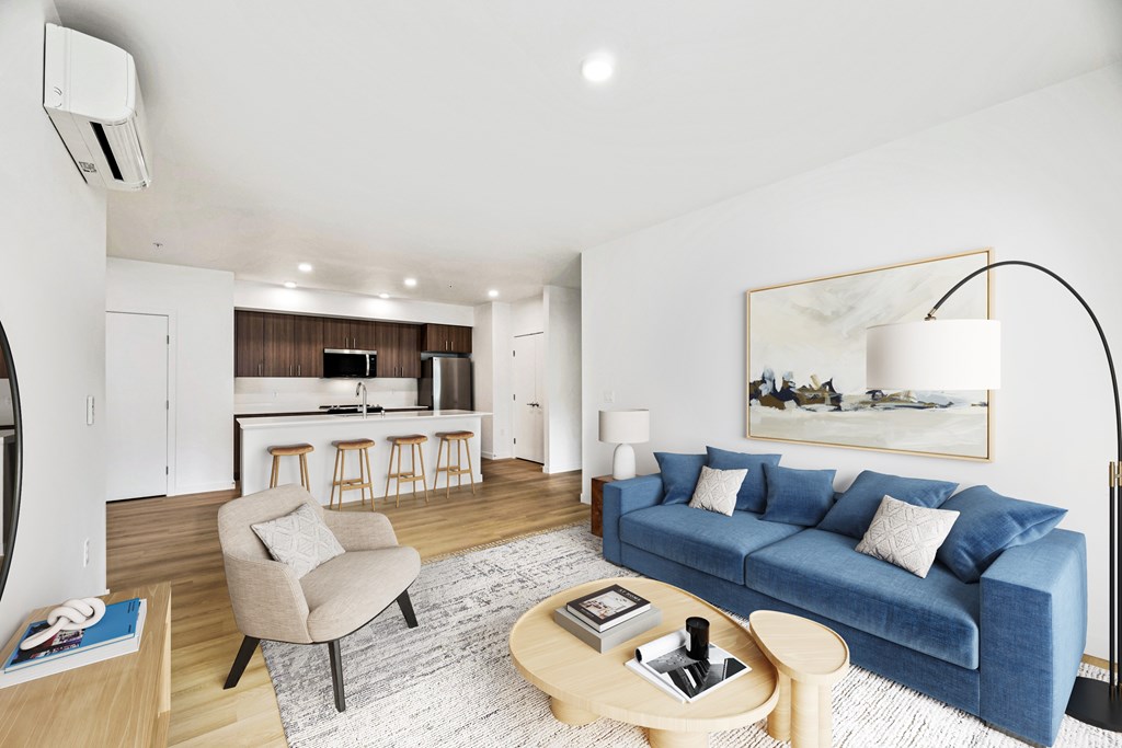 A modern living room with a blue couch and a wooden coffee table.