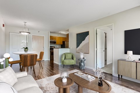 a living room and dining room with a table and chairs