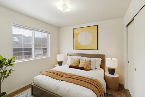 A bedroom with a large bed and a painting above it.