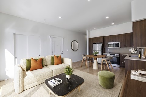 A modern living room with a white sofa and a coffee table.