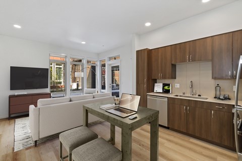 A modern kitchen with a table and chairs in the foreground.