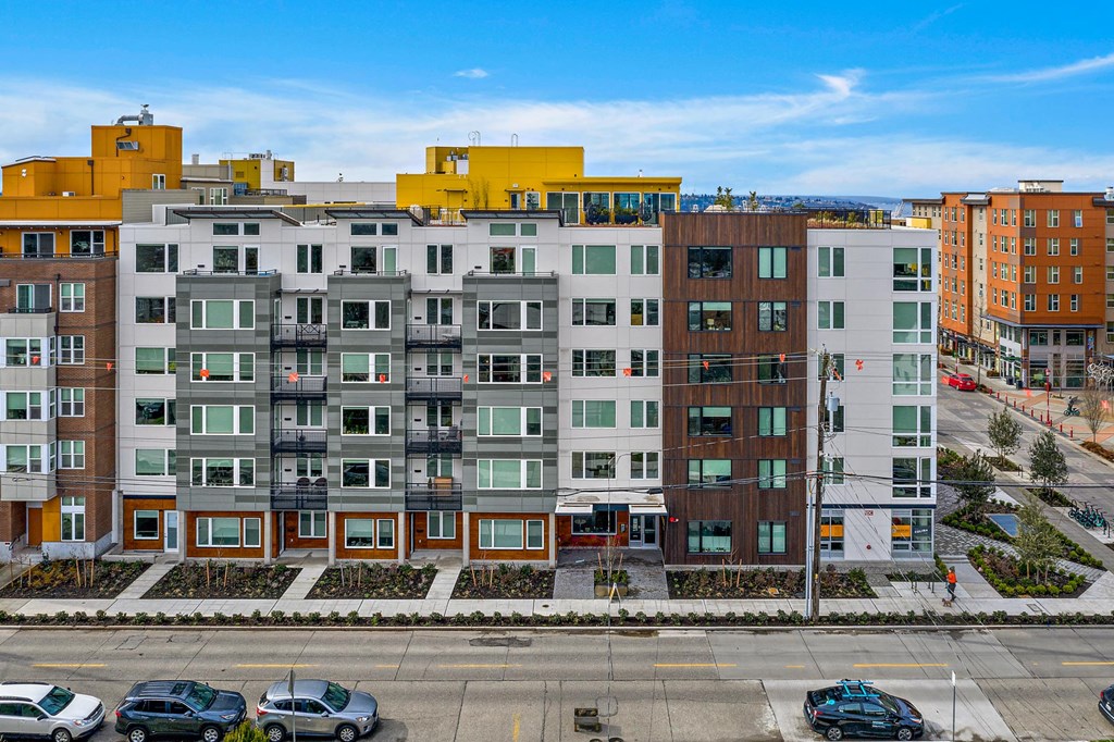 an aerial view of an apartment building in a parking lot