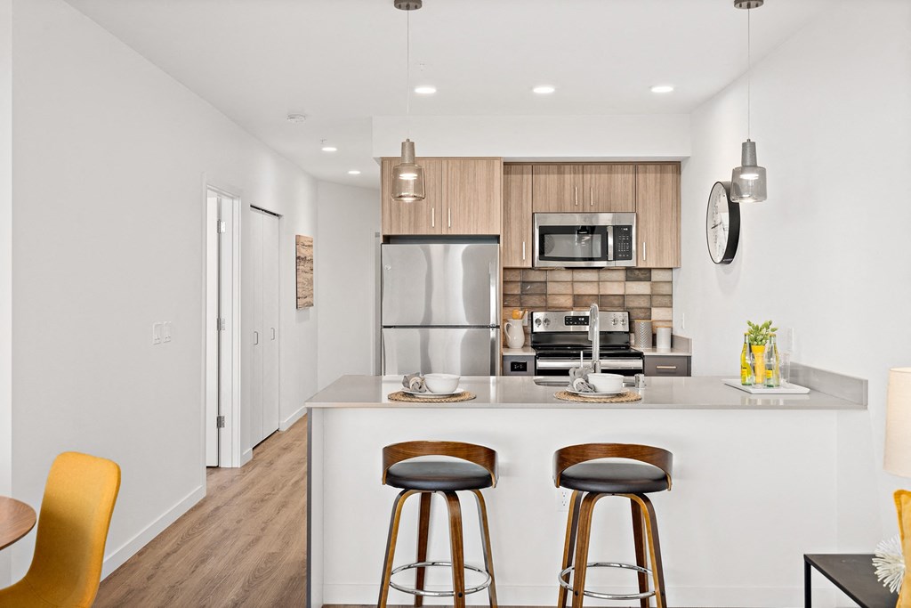 a kitchen with a island with three stools