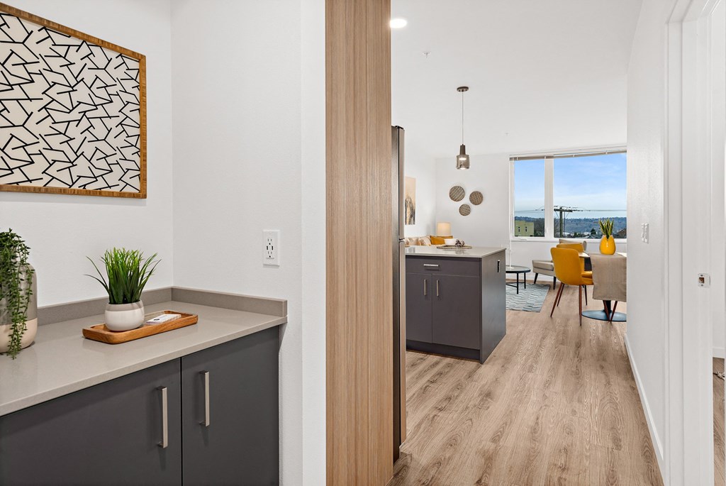 an open kitchen and living room with a view of the dining room and kitchen island